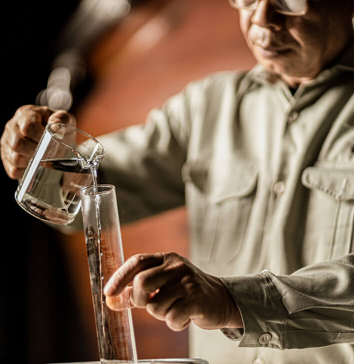 Master distiller pouring new make spirit